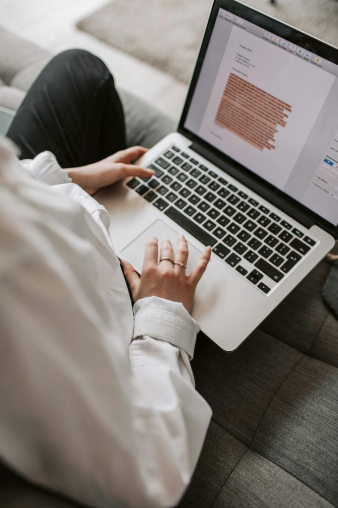 pexels photo 4050287 4050287 Woman working on a laptop indoors, focusing on document editing and remote work.