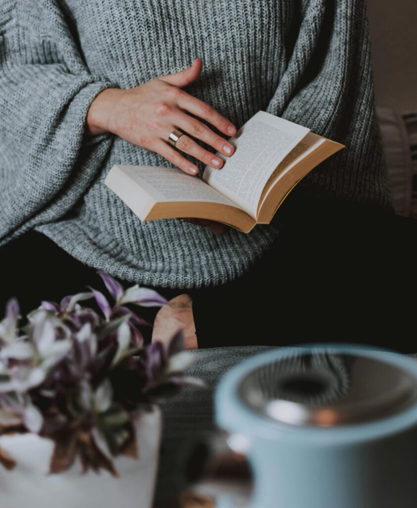 Girl reading a book symbolizing tone and style in literary translation
