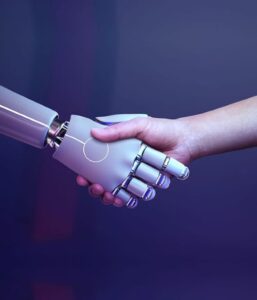 A robotic hand shaking hands with a human hand representing MTPE services.